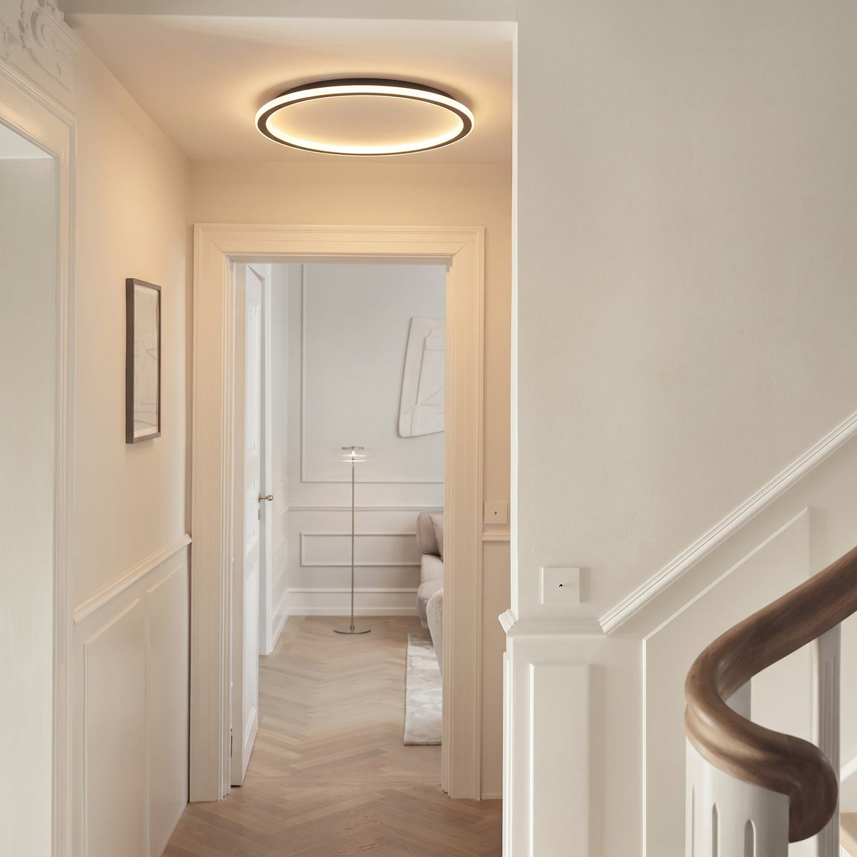 Schwarze runde LED-Deckenleuchte, weitere Ansicht im Flur.