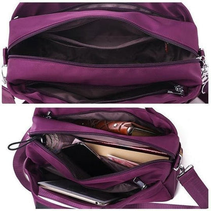 Lila Umhängetasche aus Nylon mit mehreren Fächern, ideal für Reisen und Alltag.