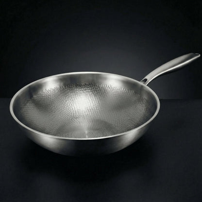 Geschmiedete Titan-Wokpfanne mit gebürsteter Metalloberfläche und langem Stielgriff, schräg von vorn.