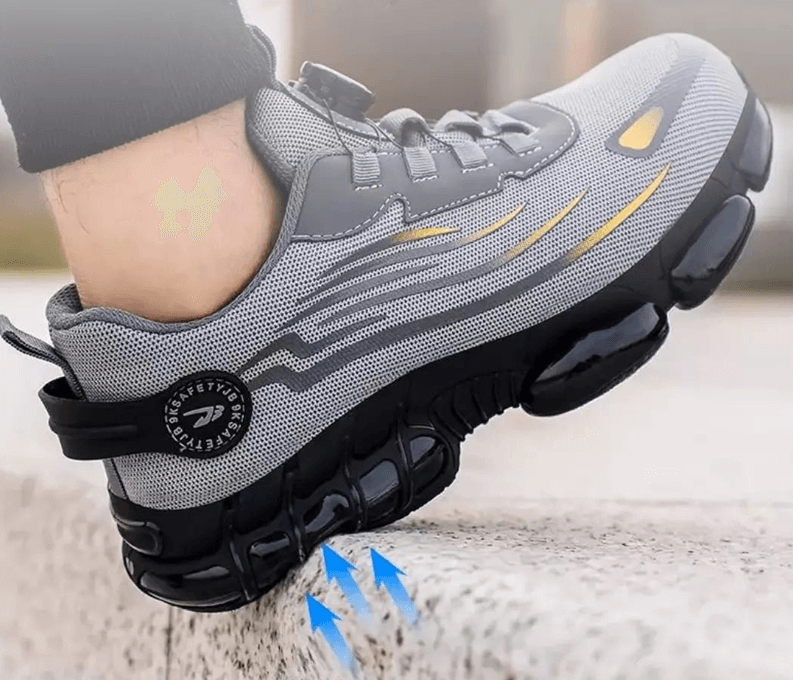 Fuß im grauen Schuh tritt auf eine Steinkante, blaue Pfeile zeigen die Dämpfung der Sohle 7