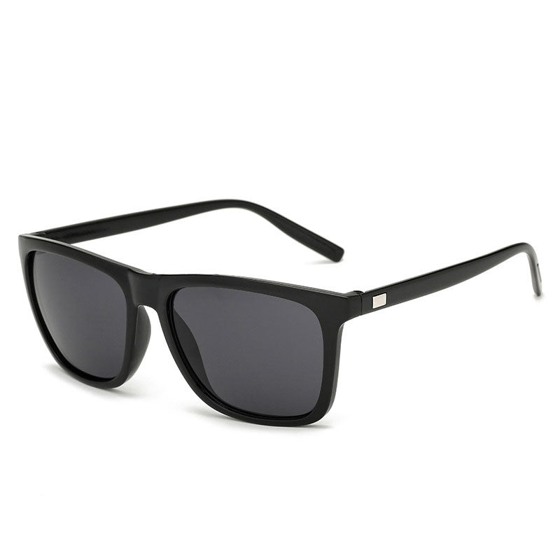 Glänzend schwarze Sonnenbrille mit dunkel getönten Gläsern in Schrägansicht auf hellem Hintergrund 13