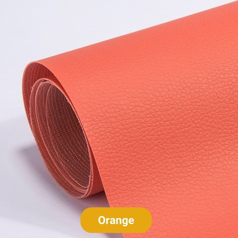 Orange aufgerollte Lederbahn mit feiner Narbung, die Rolle zeigt die helle Gewebe-Rückseite des Flickens. 21