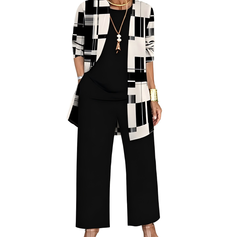Schwarz-weißes Set mit geometrisch gemustertem Cardigan, getragen mit schwarzem Shirt, schwarzer weiter Hose und Halskette. 8