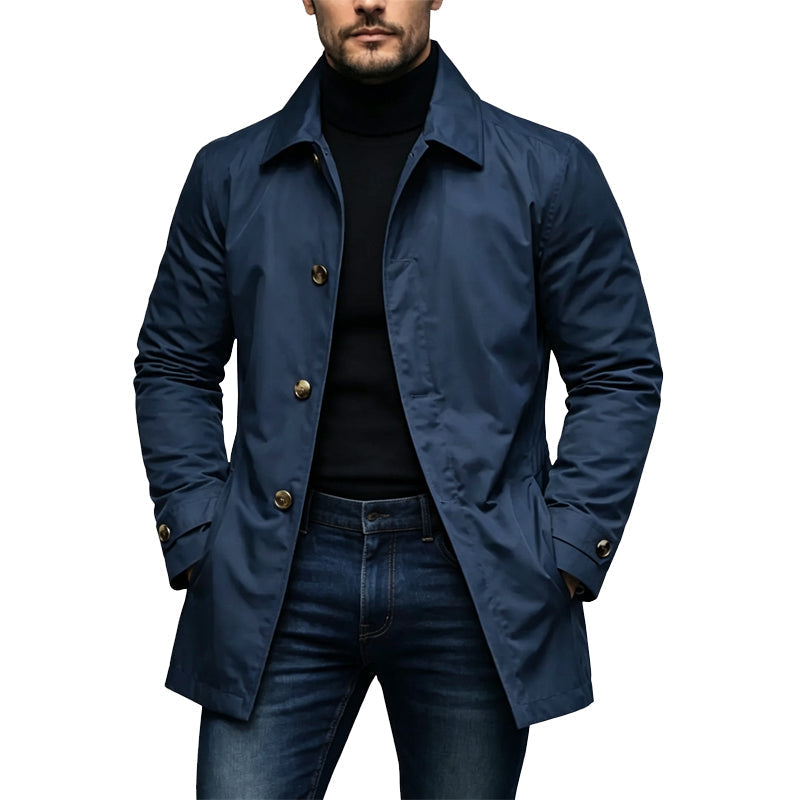 Mann trägt den Trenchcoat in Marineblau mit goldfarbenen Knöpfen, kombiniert mit schwarzem Rollkragenpullover und Jeans 3